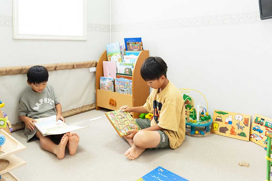 もりざね歯科医院のキッズスペースで遊ぶ2人の子供の写真